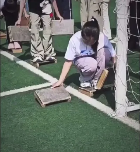 Some sort of race with wooden blocks. She's really good at it