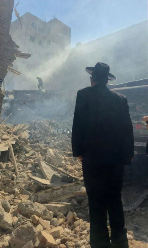 Younes Lalehzar, A Jewish community leader, stands next to ruins of Yousef Abad Synagogue in Tehran.