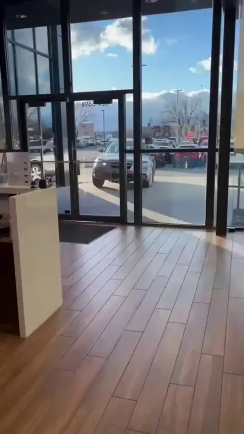 Man crashes car into dealership showroom due to overcharge.