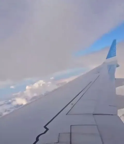 The wing flex on a Boeing 737 MAX 8 experiencing extreme turbulence.