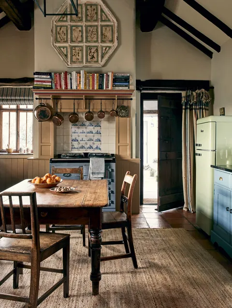 Kitchen with an inherited Aga range and an antique stained-pine farmhouse table in a 17th-century farmhouse, Lake District, Cumbria, North West England [1874x2482]