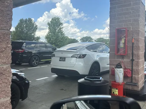 Tesla with no gas license plate takes spot at the pump.