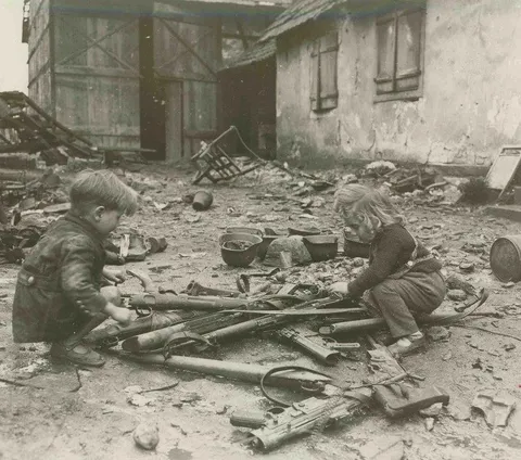 Children playing with abandoned weapons in the streets of Berlin, 1945