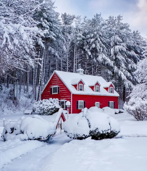 Bright red cabin in the snow, New England.