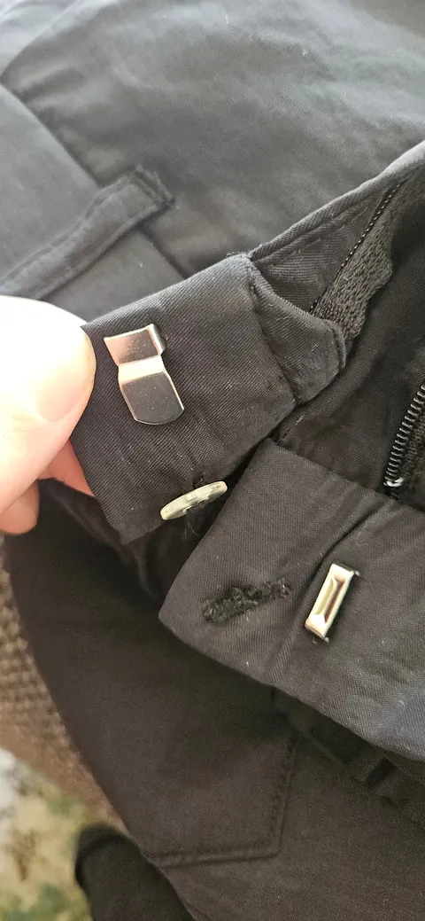Use safety pins to quickly and cheaply reduce the waist size of pants with a hook and bar closure