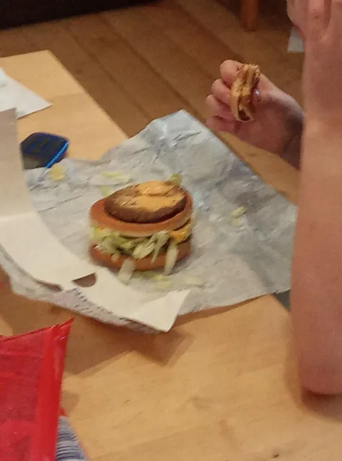 My little brother eats a burger layer by layer