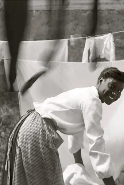 Newport, Rhode Island, 1902. "Informal portrait of a negro young woman working amid clotheslines heavy with sheets and stockings" by Gertrude Käsebier.