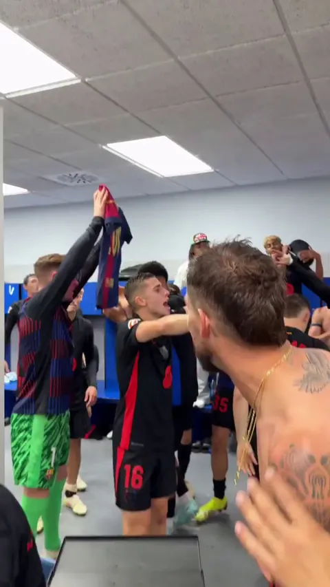 Barcelona players lift up Pedri after winning La Liga.