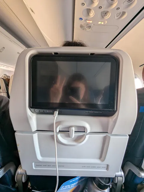 International flight, middle seat, only person on the entire full flight with a broken TV