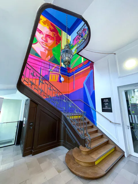 This anamorphic mural painted on the wall in a Paris Building