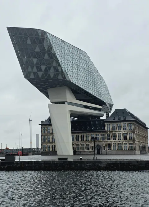 The Port House (or Havenhuis) is the iconic headquarters of the Antwerp Port Authority (Belgium). It has become one of the city's major architectural symbols. Its shape evokes both the prow of a ship and a sparkling diamond, recalling Antwerp's status as the world's diamond capital. [OC]
