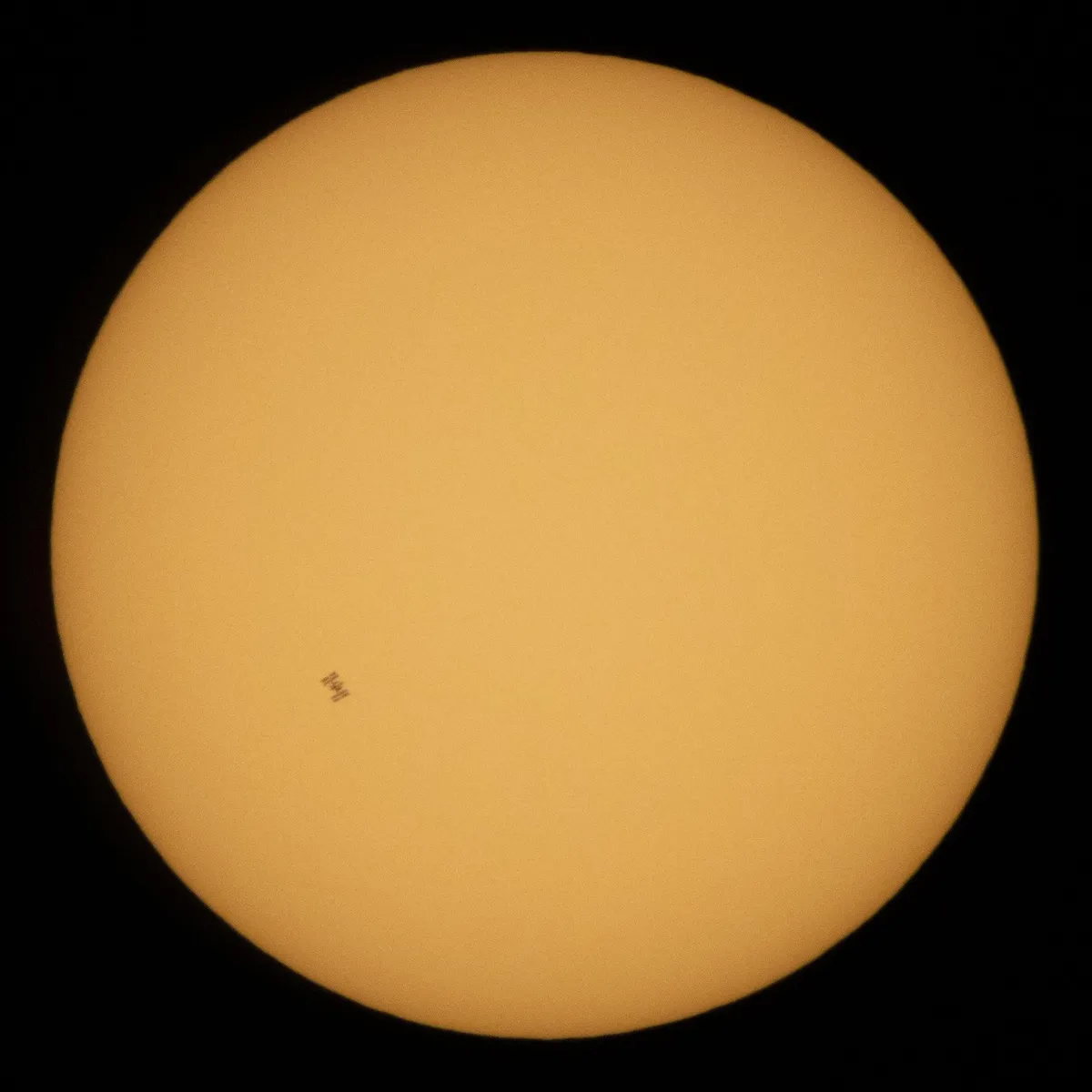 "The International Space Station, with a crew of five onboard, is seen in silhouette as it transits the Sun at roughly five miles per second [8.04672 kilometers per second], Wednesday, June 24, 2020, from" Fredericksburg, Virginia, United States of America. Photographer: Joel Kowsky, NASA