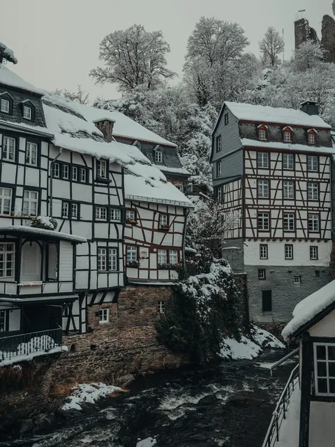 Half-timbered buildings along the Rur River flowing through the resort town of Monschau in the winter, Eifel region, Aachen, North Rhine-Westphalia, western Germany.
