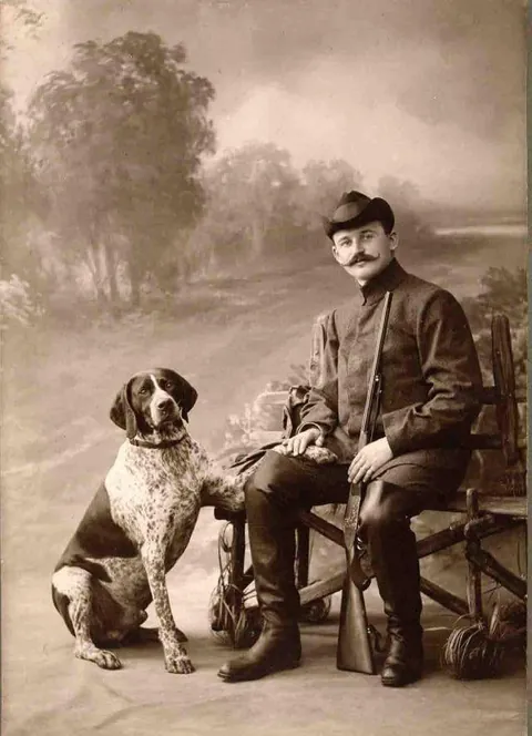 Gentleman pose for photos with their beloved pups, circa 1880-1900