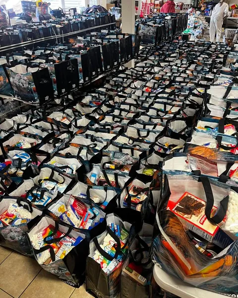 Local non-profit has put together hundreds of Thanksgiving bags to help families, and posted this picture. The person who runs it is hiding somewhere in the picture like Where's Waldo.