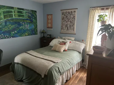 Daughter’s cozy bedroom when she visits home. She painted the mural in 2020. 
