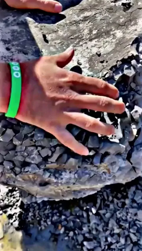 This stone effortlessly crumbling into smaller rocks