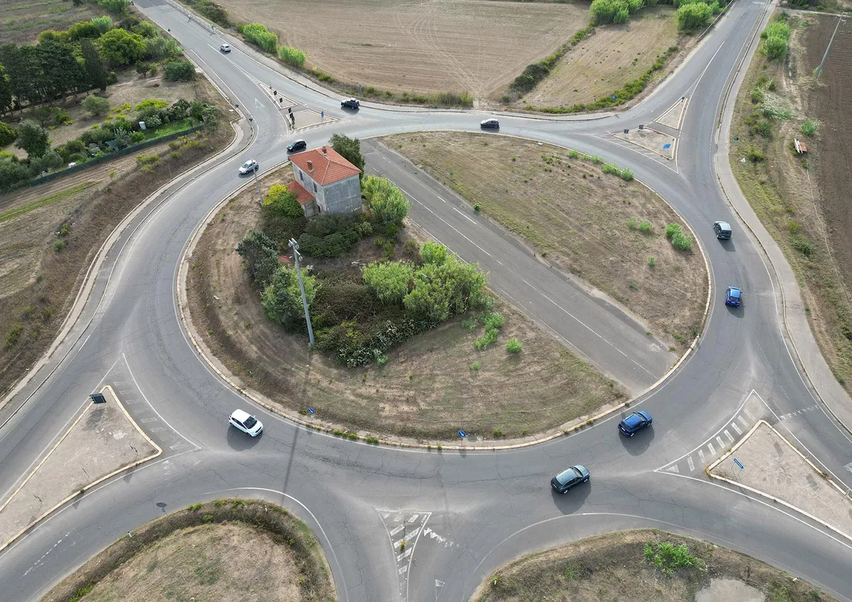 An abandoned house in the middle of a roundabout in Sardinia, Italy