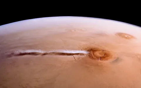 This martian cloud appears to develop every morning during the spring and summer seasons. Before dawn, a circular cap of cloud, around 125 km across, emerges over the western flank of the Arsia Mons. After sunrise it extends rapidly westwards with the prevailing winds - moving at over 600 km/h.