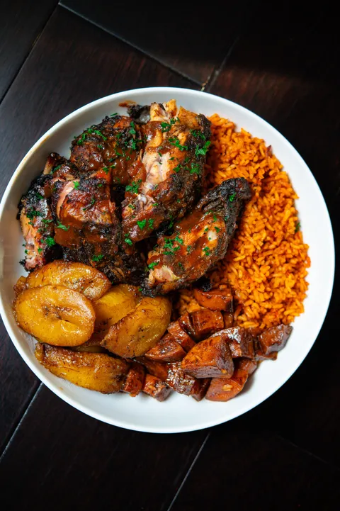 [homemade] smoked jerk chicken, jollof rice, candied yams and plantains. 