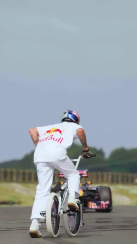 [World First] Kriss Kyle jumping a BMX over a moving F1 car