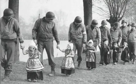 Dutch girls escorting American soldiers to a dance (after ww2)