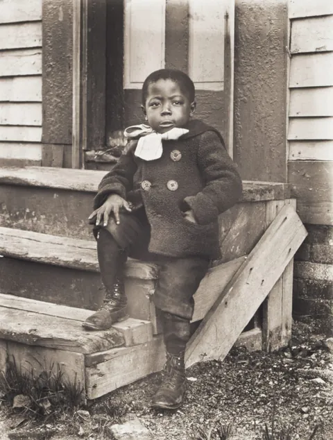 Boy posing proudly in his double breasted winter coat, Worcester, circa, 1902.