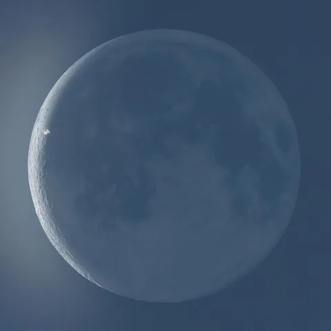 Probably my luckiest shot ever, I captured a shot of the ISS right on the terminator of a slim crescent moon. [OC]