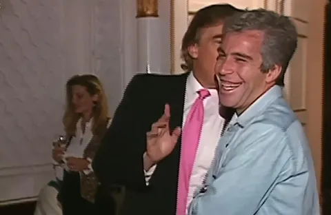 Jeffrey Epstein laughing while talking with a friend