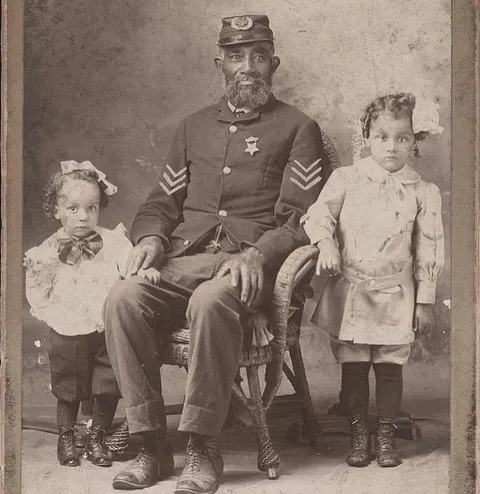 A Civil War Veteran poses with his grandchildren, Mt. Pleasant, PA, c. 1900. The Library of Congress.
