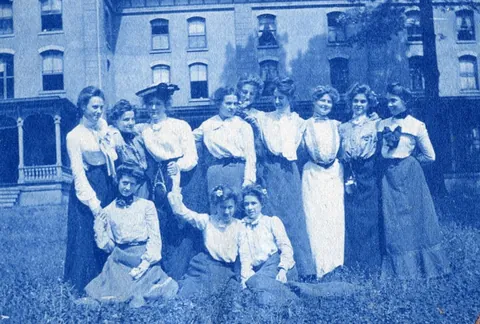 An unnamed young woman recorded her senior year at Asheville Female College in a photo album, Asheville, North Carolina, 1902. It includes a dorm room, group shots of friends, playing in snow, a visit to the mountains, their final midnight party before graduation, and graduation day itself.