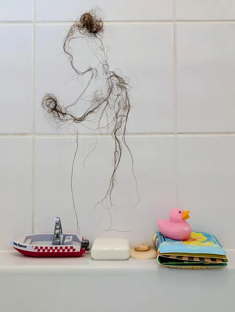 Shedding, Saz Morris, Postpartum hair on bathroom tile, 2026 [OC]
