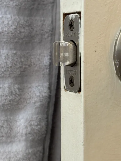 The scuff marks, the way the towel hangs, and how everything lines up makes the latch on my bathroom door look translucent