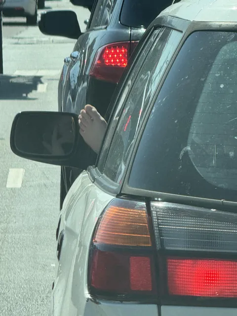 Idiot on the phone with her foot hanging out of the window [oc]