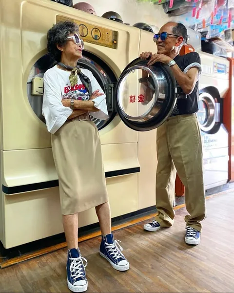 Taiwanese couple wear clothes that were left behind at their laundromat.