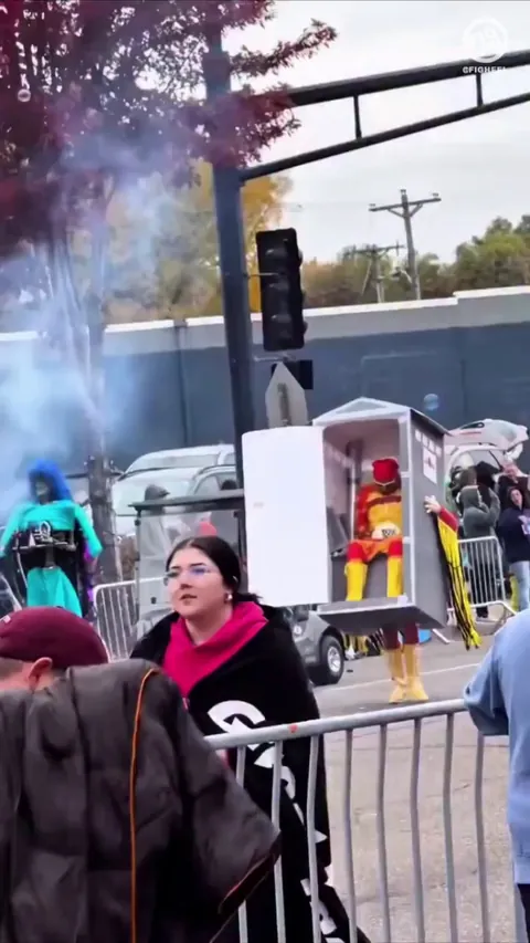 Macho Man carrying Hulk Hogan in a port a potty costume