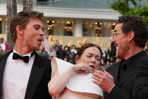 Emma stone getting scared by a bee on the red carpet