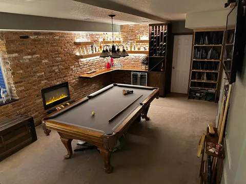 Remodeled my boring basement with reclaimed brick and structural wood