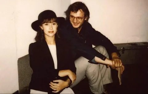 Liam Neeson smiling with his then girlfriend Helen Mirren in 1983.