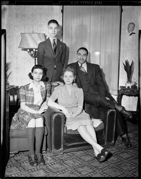 Mixed family posing for their photo Pittsburgh, circa 1940s, Agfa safety film.