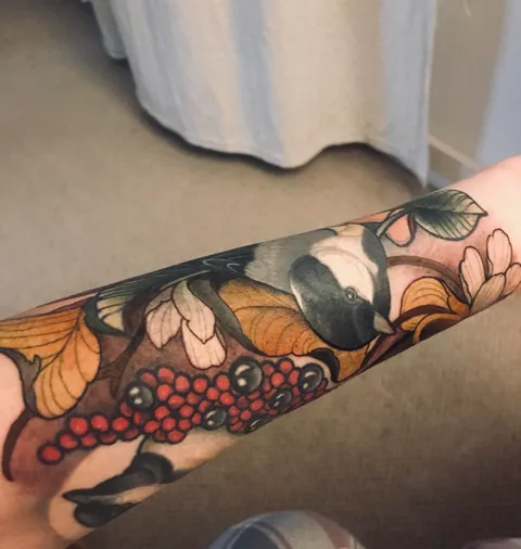 Birds and berries healed, golden leaves and flowers fresh. Chris Green at Redwood Tattoo Manchester UK.