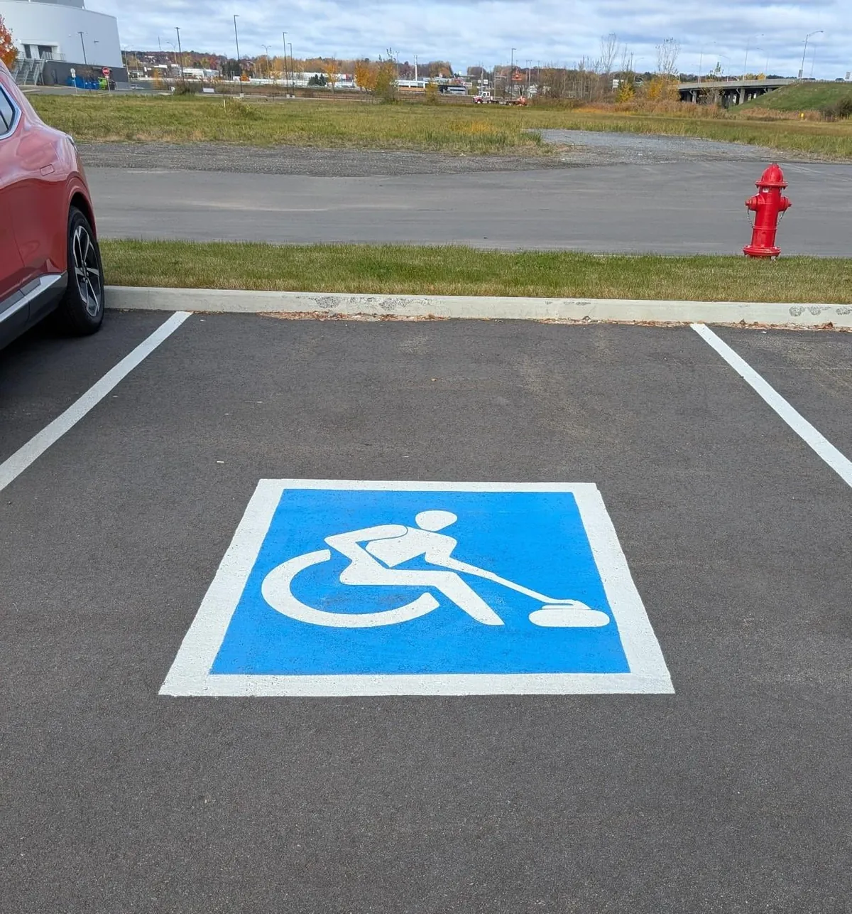 Spotted creative handicap parking signs depicting different parasports outside a sporting goods store