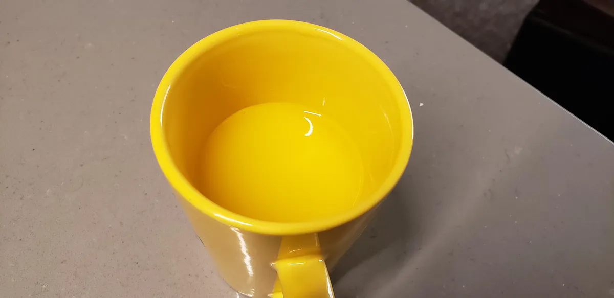 My orange juice is the same color as the mug it's in