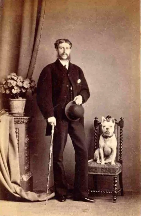 Gentleman pose for photos with their beloved pups, circa 1880-1900