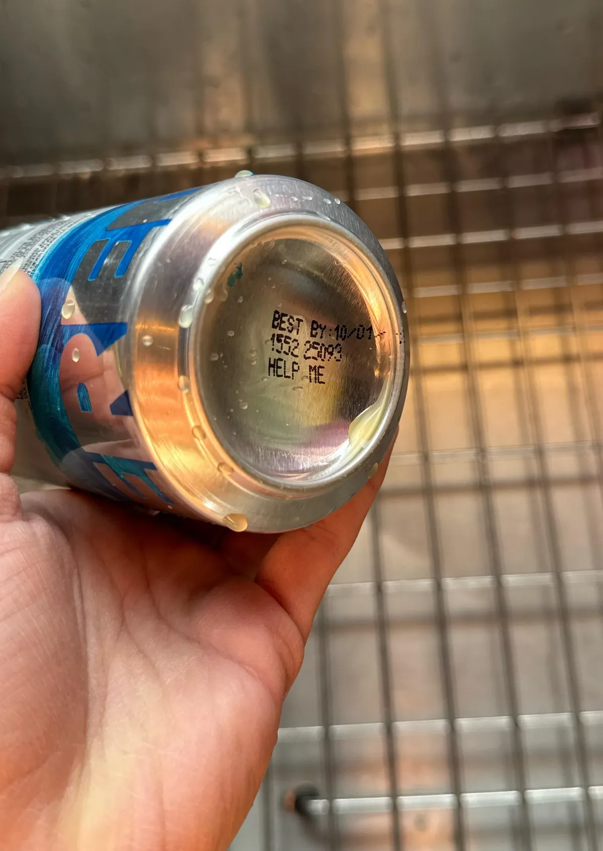 'HELP ME' print on a energy drink