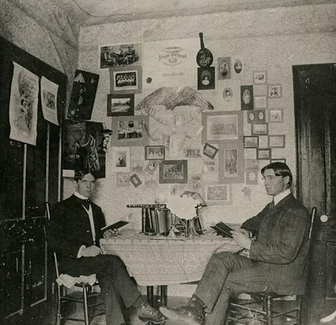Two Baylor University students study in their dorm room, 1890s.