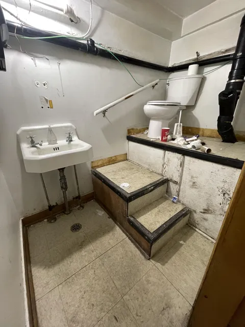 Bathroom at this restaurant, top of stair is only 4ft from the ceiling