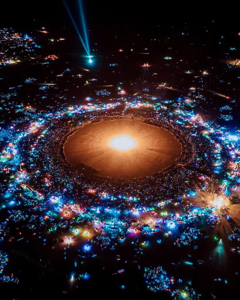 A photo of burning man that looks like a solar system