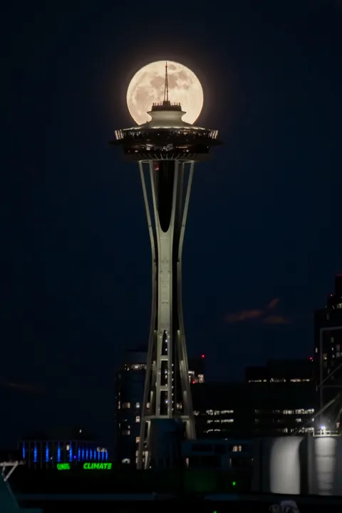 The Pink Moon rising behind the Space Needle