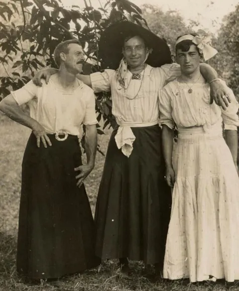 A group of Men and Women goofing around and switching clothes C 1910.